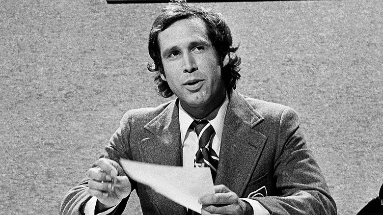 Chevy Chase at desk SNL