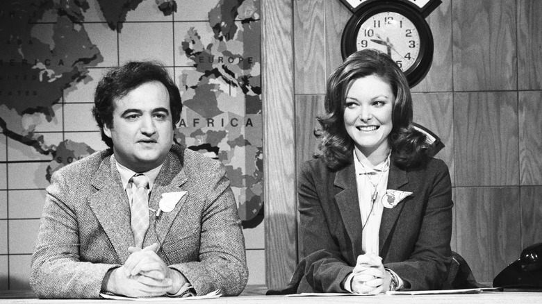 John Belushi and Jane Curtin at desk SNL