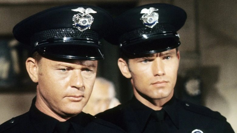 Martin Milner's Pete and Kent McCord's Jim Reed, dressed in police uniforms, look serious in Adam-12