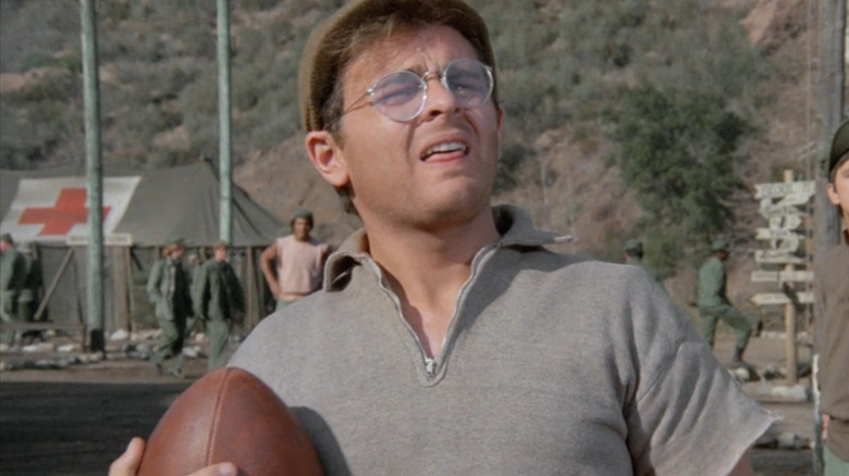 Gary Burghoff holding a football on M*A*S*H