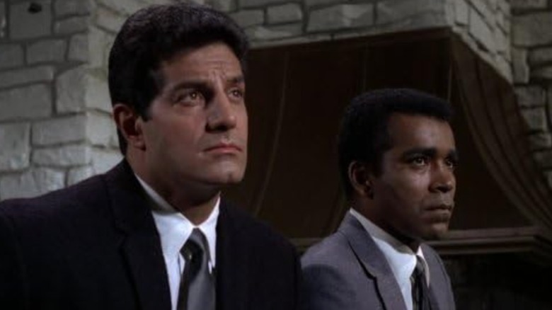 Peter Lupus and Greg Morris as Willy and Barney in Mission: Impossible, sitting side by side looking serious