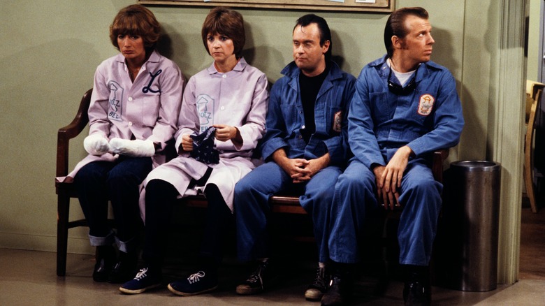 Penny Marshall as Laverne and Cindy Williams as Shirley sitting on a bench with their friends in Laverne & Shirley