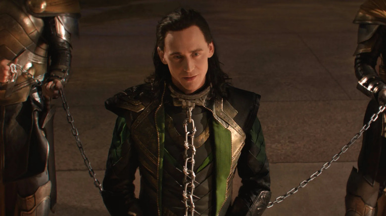 Loki stands in chains