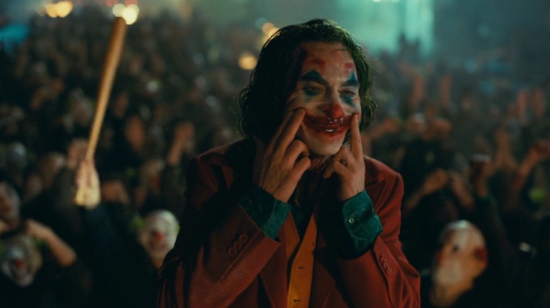 Joker paints on a smile of blood amid riots