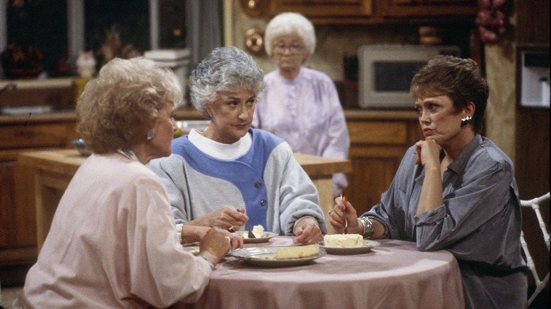 Estelle Getty as Sophia Petrillo, Bea Arthur as Dorothy Zbornak, Rue McClanahan as Blanche Devereaux and Betty White as Rose Nyland hang out on the couch in The Golden Girls