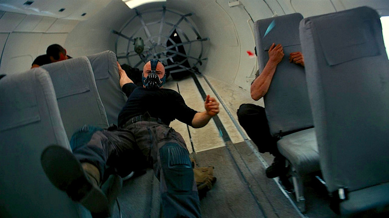 Bane Hangs from the Seat in a Vertical Plane