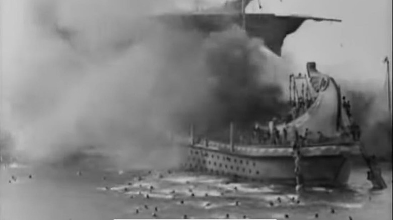 Ship on fire and extras swimming in Ben-Hur: A Tale of the Christ