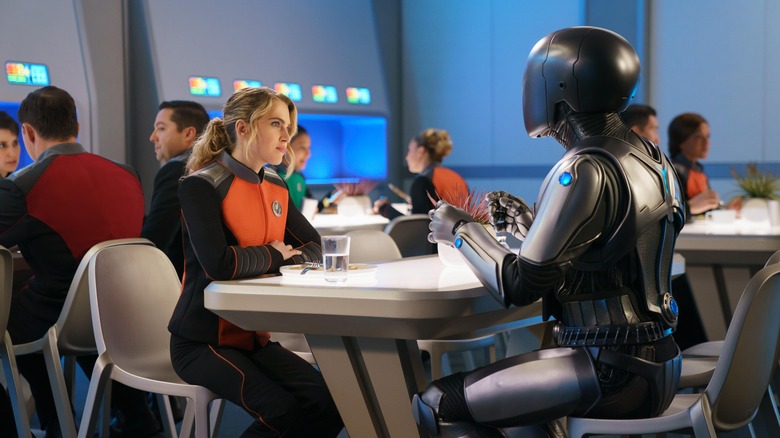 Charly and Isaac in the mess hall of The Orville: New Horizons