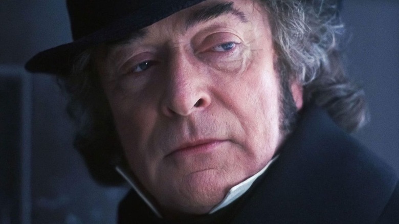 Ebenzer Scrooge shines on someone outside the screen in the Christmas Carol in Moupet