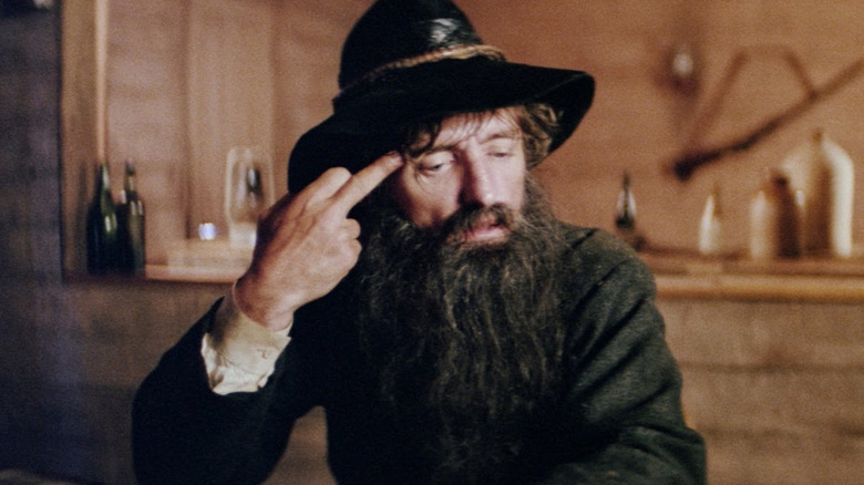 Dennis Hopper as Dan Morgan sticking out his middle finger in Mad Dog Morgan