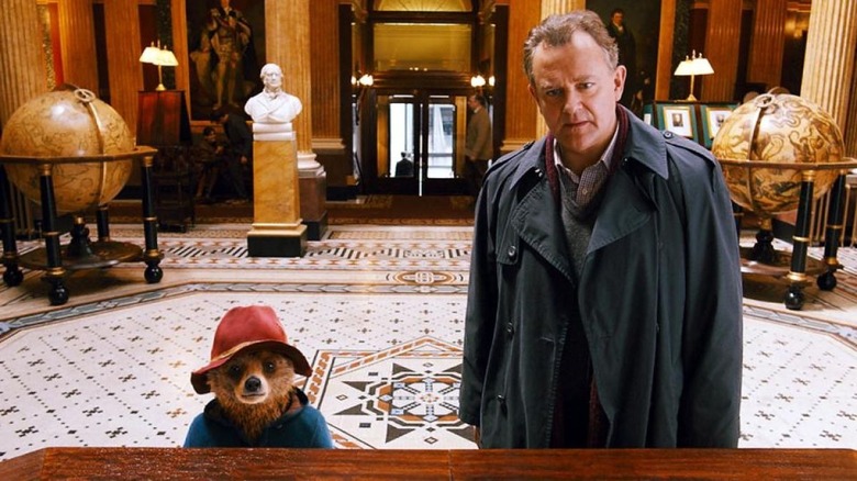 Paddington and Mr. Brown (Hugh Bonneville) at the Geographer's Guild