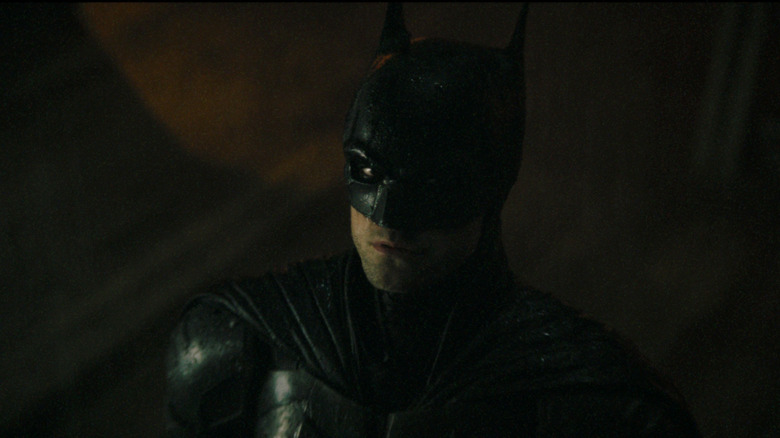 Batman looks up at the Bat-signal in The Batman