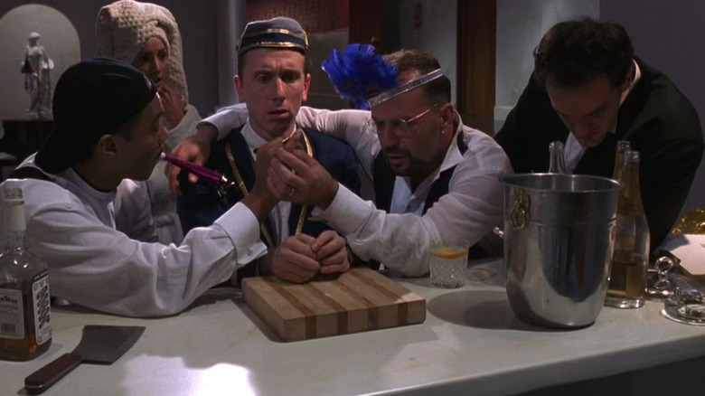 Norman and Leo explain the party's centerpiece game to Ted as Angela and Chester look on in Four Rooms