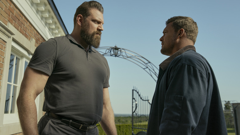 Olivier Richters as Paulie and Alan Ritchson as Reacher staring each other down in season 3 of Reacher