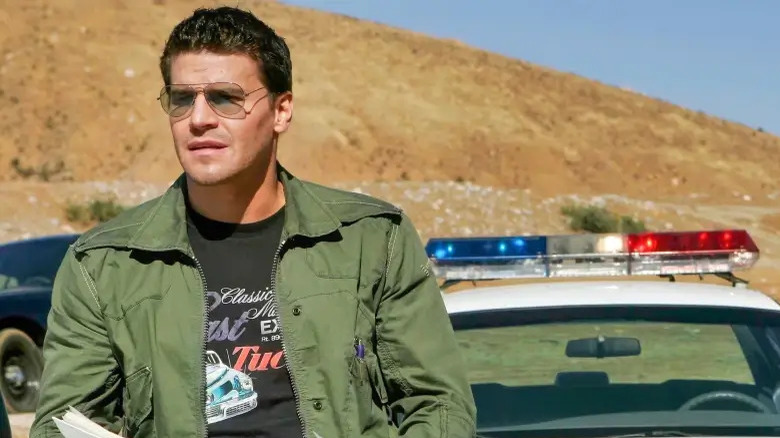 Booth wearing sunglasses in desert Bones