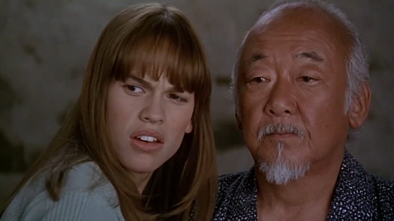 Julie Pierce standing next to Mr. Miyagi in The Next Karate Kid