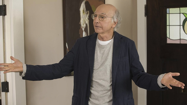 Larry David with his arms spread in Curb Your Enthusiasm