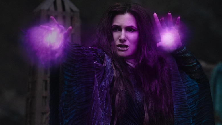 Kathryn Hahn as Agatha Harkness with purple magical engergy emitting from her hands in Agatha All Along