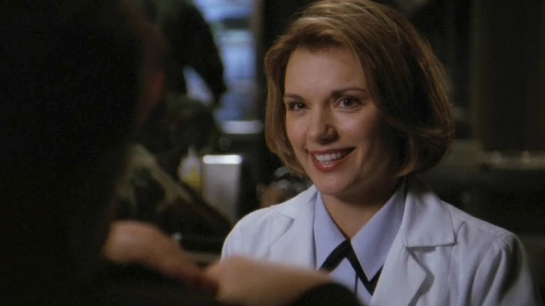 Dr. Janet Fraiser wearing a lab coat and smiling at someone in Stargate SG-1