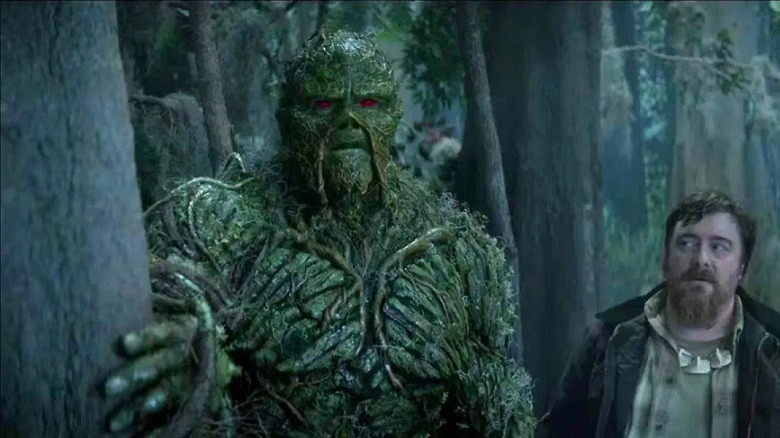 Swamp Thing and human standing in the bayou 