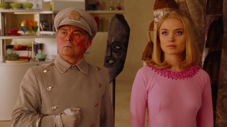 Parker and Lady Penelope from the 2004 version of Thunderbirds standing in a posh living room