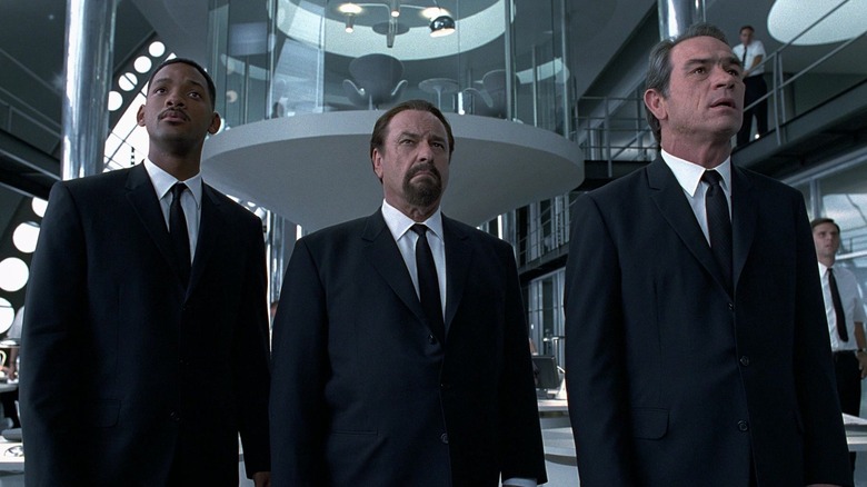 Will Smith as J, Rip Torn as Zed, and Tommy Lee Jones as K looking concerned in Men in Black