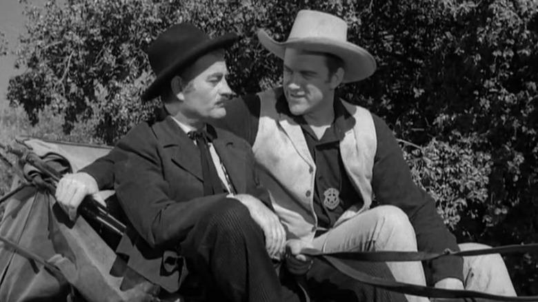 James Arness as Matt Dillon takes a carriage ride with Milburn Stone as Dr. Galen Adams in Gunsmoke