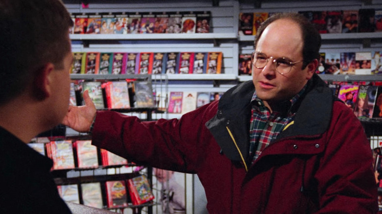 Jason Alexander as George in a video store in Seinfeld