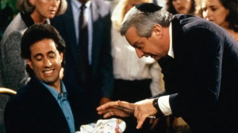 The mohel goes to work on Jerry's godchild in Seinfeld