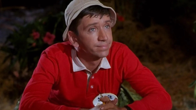 Bob Denver as Gilligan sitting with his fingers interlaced on Gilligan's Island