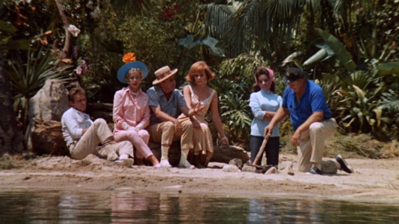 The seven castaways of "Gilligan's Island" on a beach.