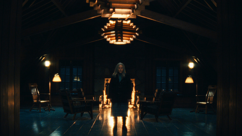 Patricia Arquette's Ms. Cobel standing in front of a fireplace on Severance