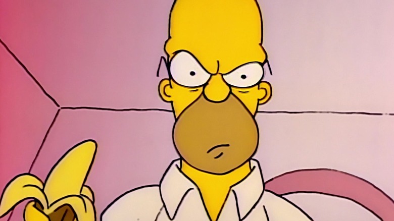 Homer Simpson looking mean, holding a banana, on The Simpsons.