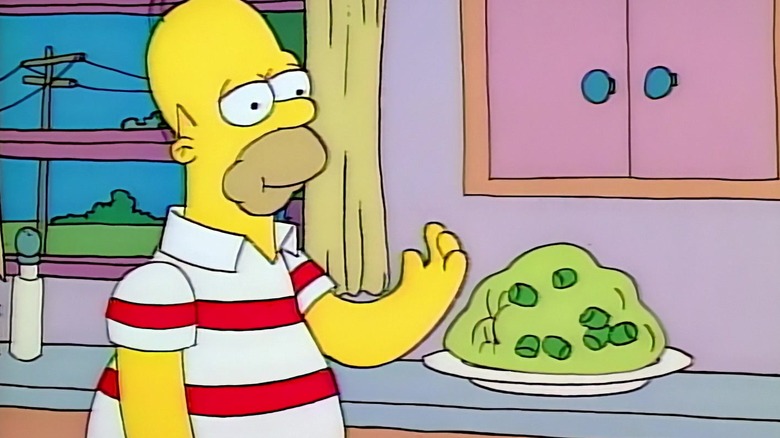 Homer in a striped shirt, eating a marshmallow out of a gelatin mold. From The Simpsons.