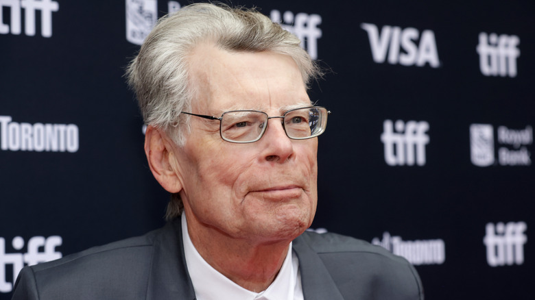 Stephen King smiling on the red carpet at the Toronto International Film Festival