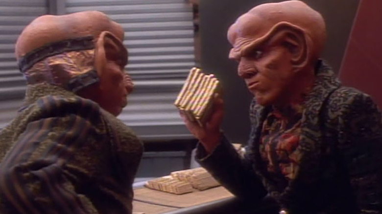 Quark holding a fistful of gold-pressed latinum on Star Trek: Deep Space Nine