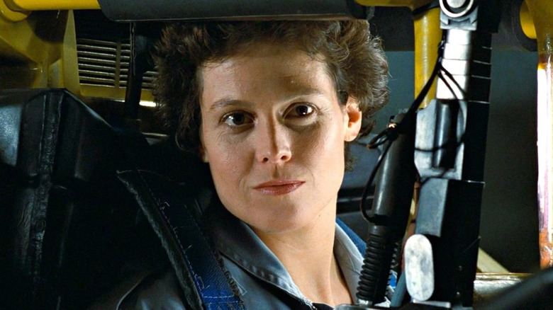 Ripley (Sigourney Weaver) confidently operates a power loader in Aliens (1986)