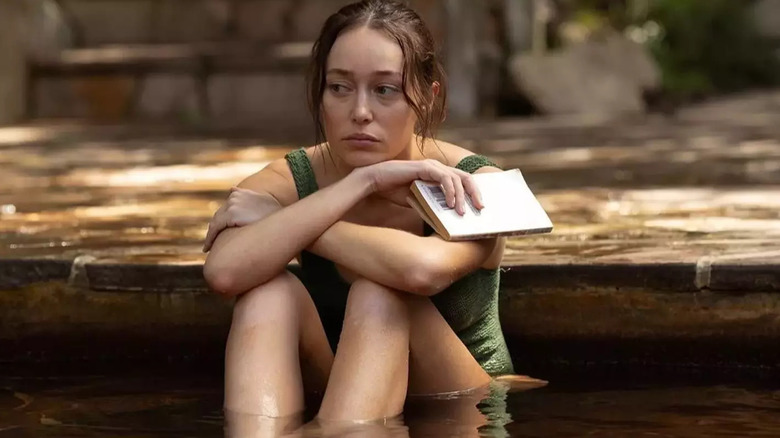 Alycia Debnam-Carey as Milla Blake sitting in a pool in Apple Cider Vinegar