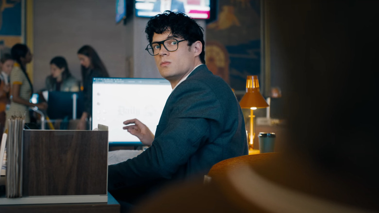 Clark Kent sits at his desk at the Daily Planet in Superman