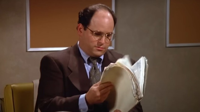 Jason Alexander's George Costanza is looking at a file on Seinfeld