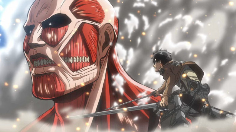 Eren Yeager staring down the Colossal Titan in Attack on Titan