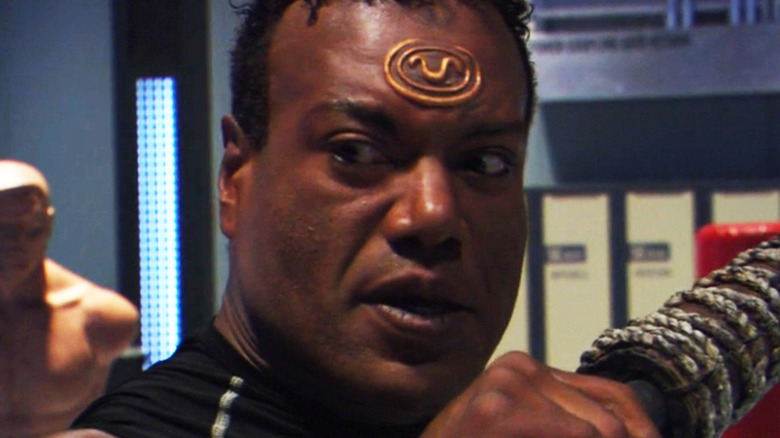 Christopher Judge's Teal'c looks intense as he guards against an attack in Stargate SG-1