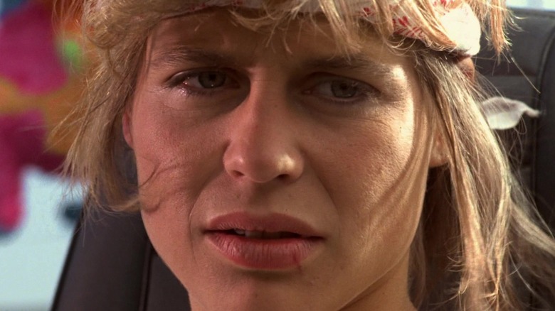 Linda Hamilton's Sarah Connor looks off camera in close-up in The Terminator