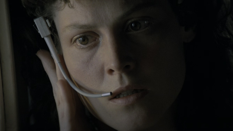 Sigourney Weaver's Ellen Ripley listens to her earpiece in Alien