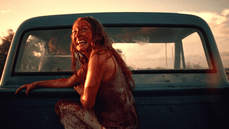 Marilyn Burns sits in the back of a truck covered in blood in The Texas Chain Saw Massacre