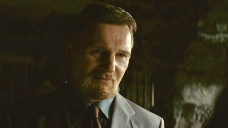 Liam Neeson's Ras Al Ghul looks across frame in The Dark Knight Rises