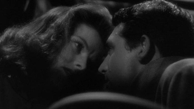 Katharine Hepburn's Tracy and Cary Grant's Dexer lean in close in The Philadelphia Story