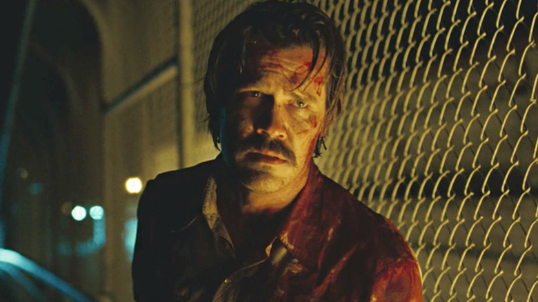 Josh Brolin behind fence