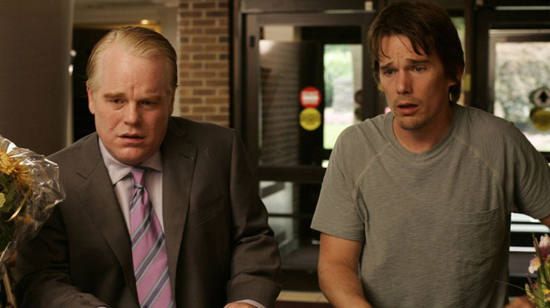 Philip Seymour Hoffman and Ethan Hawke looking distraught