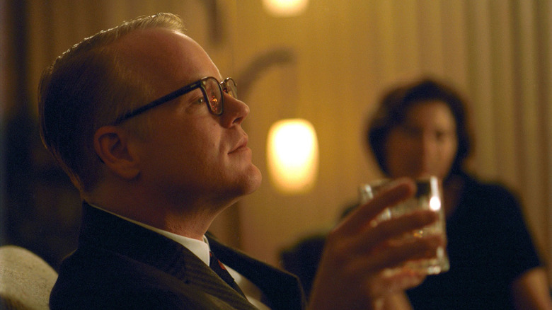 Philip Seymour Hoffman as Truman Capote drinking